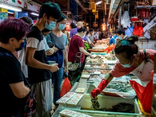 Nhiều người đeo khẩu trang khi đang đi chợ cá ở Hong Kong. Ảnh: AP/CNN
