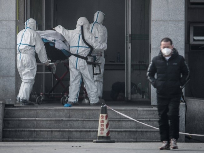 Nhân viên y tế tại một bệnh viện ở Vũ Hán đang di chuyển một nạn nhân nhiễm virus Corona hôm 31-1. Ảnh: AFP