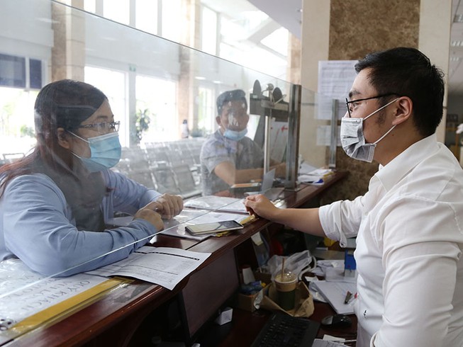 Quy định thuế TNDN tại Nghị định 126 là không phù hợp thực tế. Trong ảnh: Doanh nghiệp làm thủ tục thuế tại Cục Thuế TP.HCM. Ảnh: HOÀNG GIANG