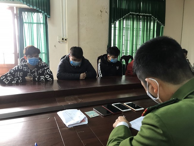 Công an làm việc với nhóm người lừa đảo qua mạng. Ảnh: ND