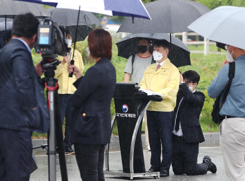 Để nhân viên quỳ gối che ô, Thứ trưởng Hàn Quốc nhận chỉ trích dữ dội - ảnh 1